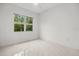 Bright bedroom with a view of lush landscaping through the window at 4528 Yorkshire Ln, Kissimmee, FL 34758