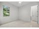 Bright bedroom with natural light, neutral walls, and views of the landscaping at 4528 Yorkshire Ln, Kissimmee, FL 34758