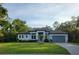 Beautiful single-story home boasts a manicured lawn, neutral paint, and an attached two car garage at 4528 Yorkshire Ln, Kissimmee, FL 34758