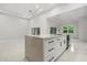 Bright kitchen features a quartz island, white cabinets, and stainless steel appliances at 4528 Yorkshire Ln, Kissimmee, FL 34758