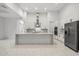 Modern kitchen with white cabinets, island, and stainless steel appliances at 4528 Yorkshire Ln, Kissimmee, FL 34758