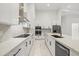 Modern kitchen with white cabinetry, quartz countertops, stainless steel appliances, and center island at 4528 Yorkshire Ln, Kissimmee, FL 34758