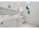 Efficient laundry area with modern appliances and storage cabinets at 4528 Yorkshire Ln, Kissimmee, FL 34758