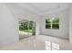 Bright living room with large windows, sliding glass door, and light, marble-look flooring at 4528 Yorkshire Ln, Kissimmee, FL 34758