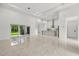 Open-concept living area with sliding glass doors and a modern kitchen at 4528 Yorkshire Ln, Kissimmee, FL 34758
