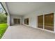 Covered patio with tile flooring and multiple sliding glass doors offer a seamless transition to the outdoors at 4528 Yorkshire Ln, Kissimmee, FL 34758