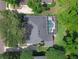Aerial view of a well-maintained property with a screened-in pool and lush green surroundings at 460 W Palm Valley Dr, Oviedo, FL 32765