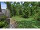 Expansive backyard featuring lush green grass and mature trees offering shade and privacy at 460 W Palm Valley Dr, Oviedo, FL 32765