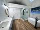 Modern bathroom featuring double vanities, a sleek glass-enclosed shower, and a freestanding bathtub at 460 W Palm Valley Dr, Oviedo, FL 32765