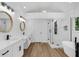 Bright bathroom with double vanity, white cabinets, and a modern glass shower at 460 W Palm Valley Dr, Oviedo, FL 32765