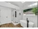 Bright bathroom featuring a modern shower with soaking tub and marble accent wall at 460 W Palm Valley Dr, Oviedo, FL 32765