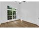 Sunny bedroom with hardwood flooring and a large window at 460 W Palm Valley Dr, Oviedo, FL 32765