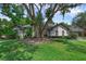Charming single-story home featuring stucco exterior, mature landscaping, and a well-manicured lawn at 460 W Palm Valley Dr, Oviedo, FL 32765
