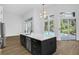 Open kitchen with island sink, stainless steel appliances, and view to backyard pool at 460 W Palm Valley Dr, Oviedo, FL 32765