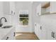 Bright kitchenette with white cabinets, white countertops, black hardware, and light wood look flooring at 460 W Palm Valley Dr, Oviedo, FL 32765