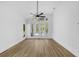 Bright living room featuring hardwood floors, large windows, and doors leading to the pool at 460 W Palm Valley Dr, Oviedo, FL 32765