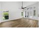 Bright living room featuring hardwood floors, large windows, and doors leading to the pool at 460 W Palm Valley Dr, Oviedo, FL 32765