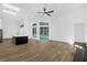 Open-concept living room boasts high ceilings, modern light fixtures, and large windows overlooking the backyard pool at 460 W Palm Valley Dr, Oviedo, FL 32765