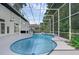 Screened-in pool area with a kidney-shaped pool featuring blue tile and a covered patio at 460 W Palm Valley Dr, Oviedo, FL 32765