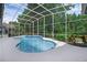 Screened in ground pool surrounded by a white deck and tropical landscaping creating a backyard oasis at 460 W Palm Valley Dr, Oviedo, FL 32765