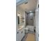 Stylish bathroom with a gray accent wall, a double vanity, and a bathtub with a shower at 5110 Sw 158Th St, Ocala, FL 34473