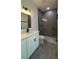 Modern bathroom featuring dual sinks, black hardware, and glass-enclosed shower at 5110 Sw 158Th St, Ocala, FL 34473