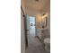 Bathroom features modern vanity with an open doorway to the kitchen at 5110 Sw 158Th St, Ocala, FL 34473