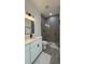 Modern bathroom featuring dual sinks, black hardware, and glass-enclosed shower at 5110 Sw 158Th St, Ocala, FL 34473