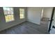 Empty bedroom with gray wood-look flooring and lots of natural light at 5110 Sw 158Th St, Ocala, FL 34473