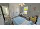 Bright bedroom decorated with hot air balloon wall decor, desk, and a gray wood-look floor at 5110 Sw 158Th St, Ocala, FL 34473