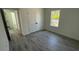 This bedroom has gray wood-look floors, and an en-suite closet with bifold doors at 5110 Sw 158Th St, Ocala, FL 34473