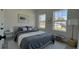 Bedroom with plentiful natural light, gray flooring, and modern decor at 5110 Sw 158Th St, Ocala, FL 34473