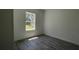 Neutral-colored room features a luxury vinyl floor and a large window that offers plenty of natural light at 5110 Sw 158Th St, Ocala, FL 34473