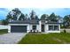 Beautiful single Gathering home featuring a modern exterior with a gray driveway and landscaped front yard at 5110 Sw 158Th St, Ocala, FL 34473