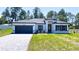 Inviting curb appeal in this single Gathering home with black trim and a paved driveway and landscaped front yard at 5110 Sw 158Th St, Ocala, FL 34473
