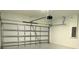 Garage door opened with white walls, ready for vehicle storage at 5110 Sw 158Th St, Ocala, FL 34473
