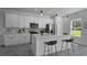 Beautiful, modern kitchen featuring white cabinets, stainless steel appliances, and a quartz countertop island at 5110 Sw 158Th St, Ocala, FL 34473