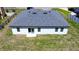 Rear exterior view of a single Gathering home with a manicured lawn and a sliding glass door at 5110 Sw 158Th St, Ocala, FL 34473