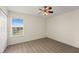Cozy bedroom with modern ceiling fan, bright window, and clean interior, providing a welcoming space at 5447 Vineland Rd # 1308, Orlando, FL 32811