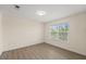 Bright bedroom with large window and modern flooring, offering a serene and comfortable space at 5447 Vineland Rd # 1308, Orlando, FL 32811