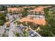 Aerial view of the community center, pool, parking spaces, and tropical landscaping at 5447 Vineland Rd # 1308, Orlando, FL 32811