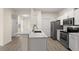 Modern kitchen features stainless steel appliances, white cabinets and new countertops, seamlessly connects to living areas at 5447 Vineland Rd # 1308, Orlando, FL 32811
