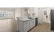 Open-concept kitchen featuring white countertops, stainless steel appliances, and ample cabinet space at 5447 Vineland Rd # 1308, Orlando, FL 32811