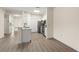 Modern kitchen featuring white cabinetry, stainless steel appliances, and hardwood floors at 5447 Vineland Rd # 1308, Orlando, FL 32811