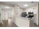 Open kitchen with white counters, stainless steel appliances, and hardwood floors at 5447 Vineland Rd # 1308, Orlando, FL 32811