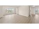 Bright living room with neutral walls, hardwood floors, and lots of natural light at 5447 Vineland Rd # 1308, Orlando, FL 32811
