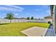 Spacious backyard features a well-maintained lawn, white fence, and a concrete patio area at 5857 Beefmaster Rd, St Cloud, FL 34771