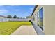 Fenced backyard with a well-maintained lawn and access to the home at 5857 Beefmaster Rd, St Cloud, FL 34771