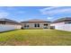 A fully fenced backyard with healthy lawn and a sliding glass door provide access to the home at 5857 Beefmaster Rd, St Cloud, FL 34771
