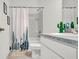 Clean, white bathroom with a cactus-themed shower curtain and modern fixtures at 5857 Beefmaster Rd, St Cloud, FL 34771